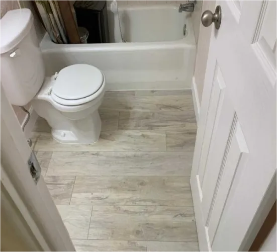 Waterproof driftwood-look plank flooring installed in a Sarasota bathroom