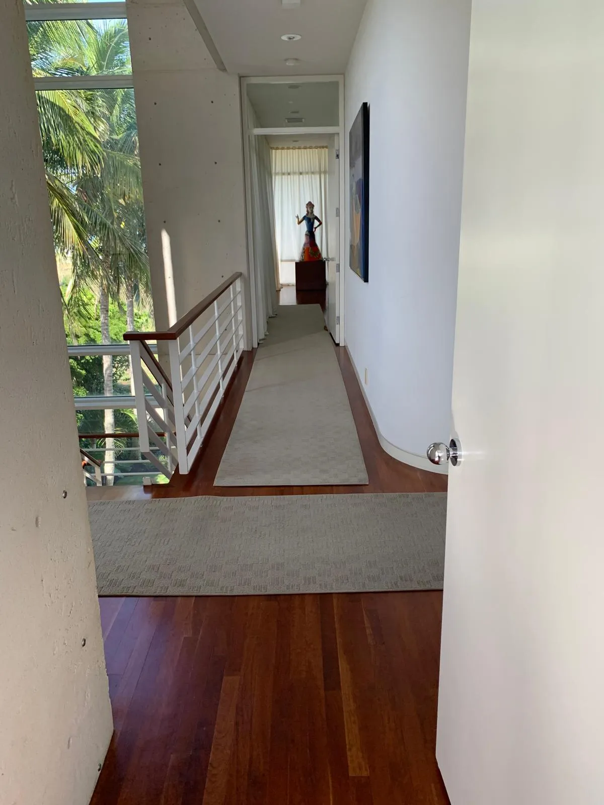 Rich cherry hardwood hallway and landing in a contemporary Gulf Coast home