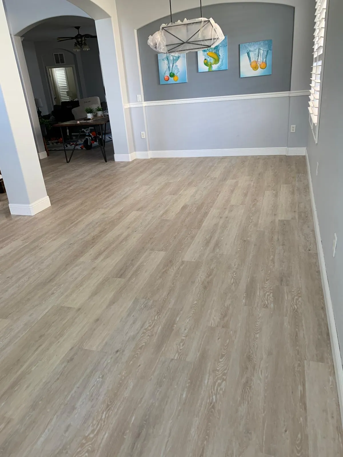 Finished waterproof plank floor in a lived-in Sarasota home, clean and ready to use