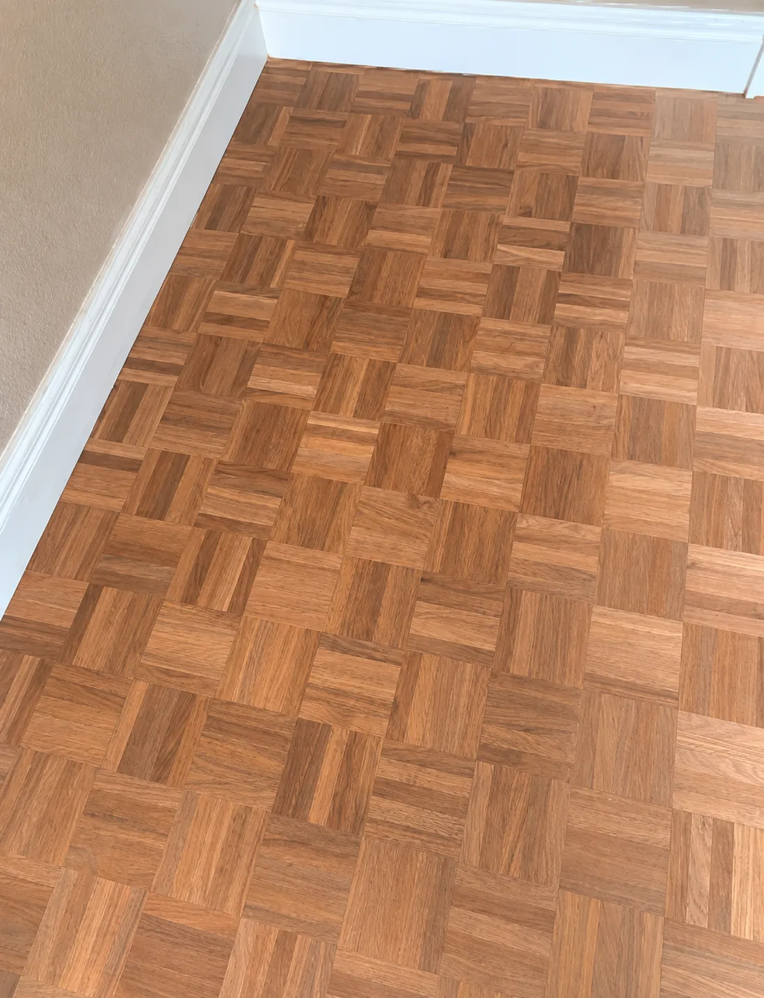 Basketweave parquet floor in a faded natural tone before refinishing