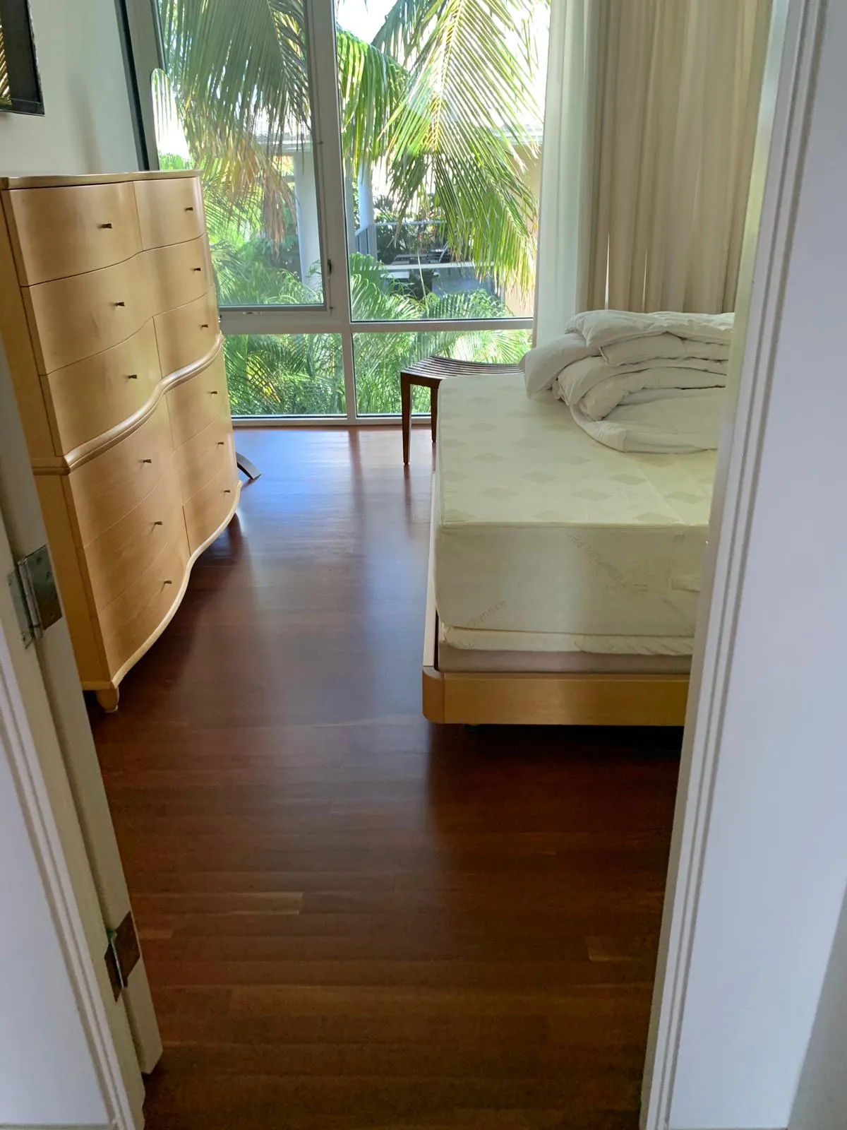 Dark ebony hardwood floor installed in a Sarasota bedroom by EGR Wood Floors
