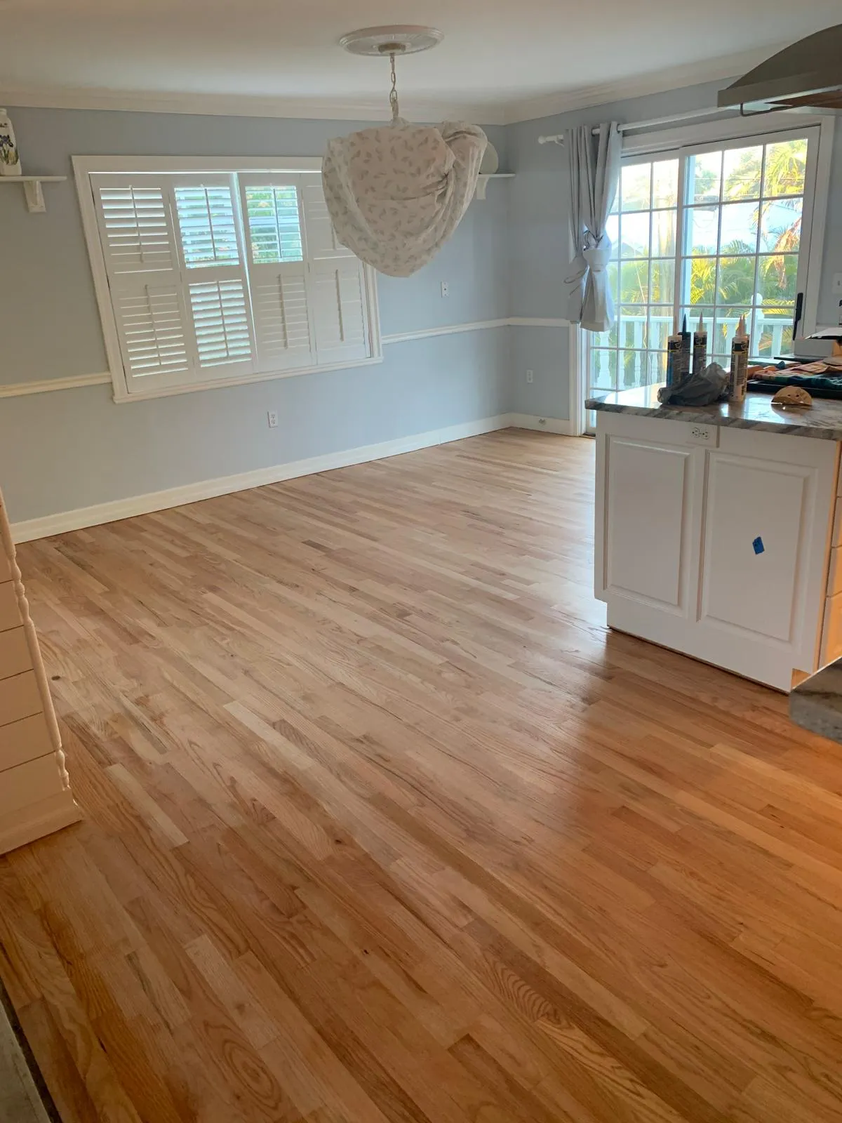 Natural oak plank hardwood flooring in a Sarasota living room and kitchen