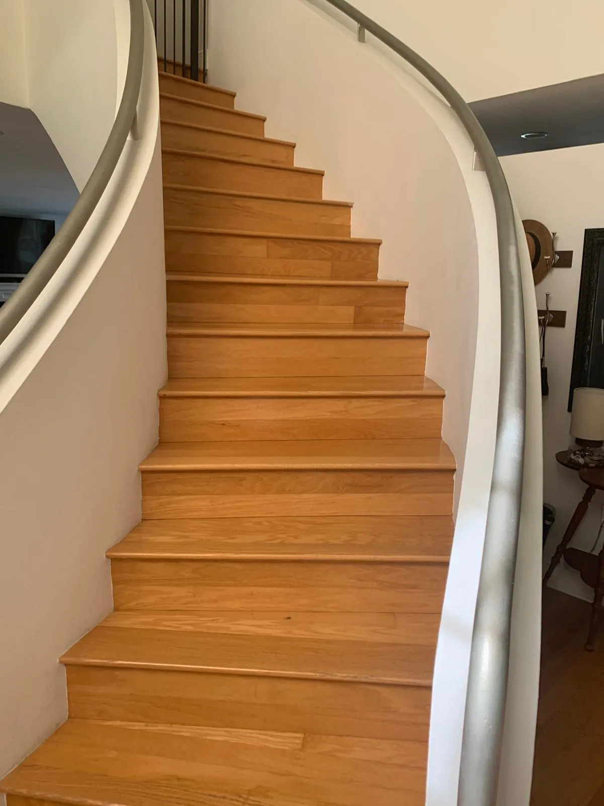 Curved red oak staircase with custom-fitted treads and risers in a Sarasota home