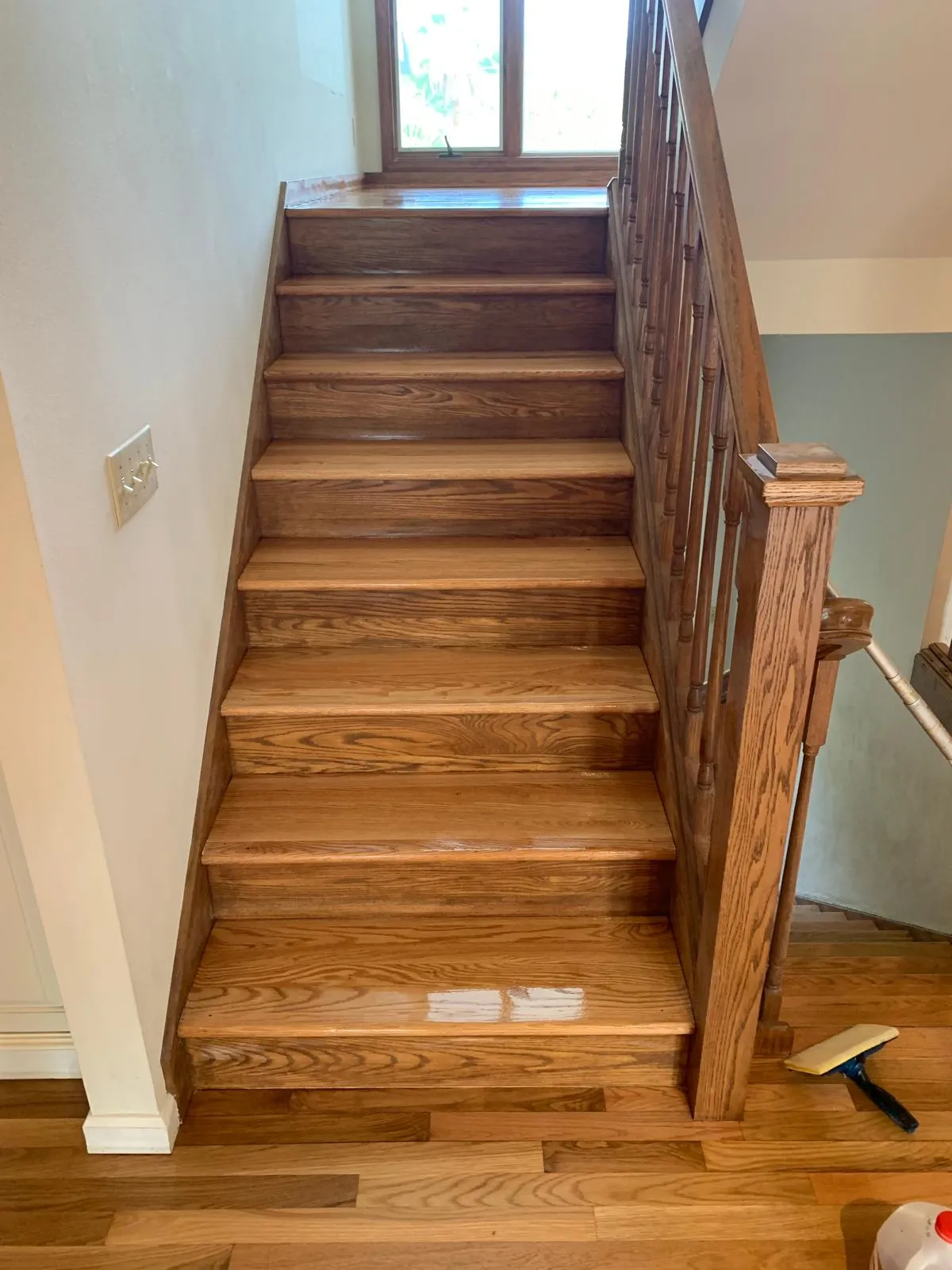 Oak staircase sanded and refinished with a fresh clear coat in a Sarasota home