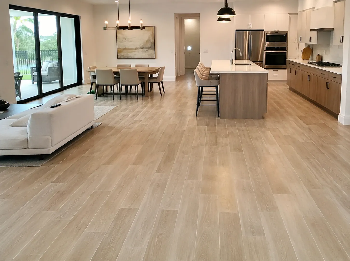 Light wide-plank oak floor in a modern open-plan Sarasota home, installed by Eduardo of EGR Wood Floors